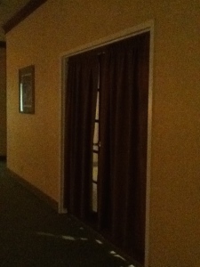 Curtained entrance to an empty meeting room.